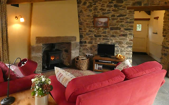Monkstone Cottage - cosy lounge with woodburning stove