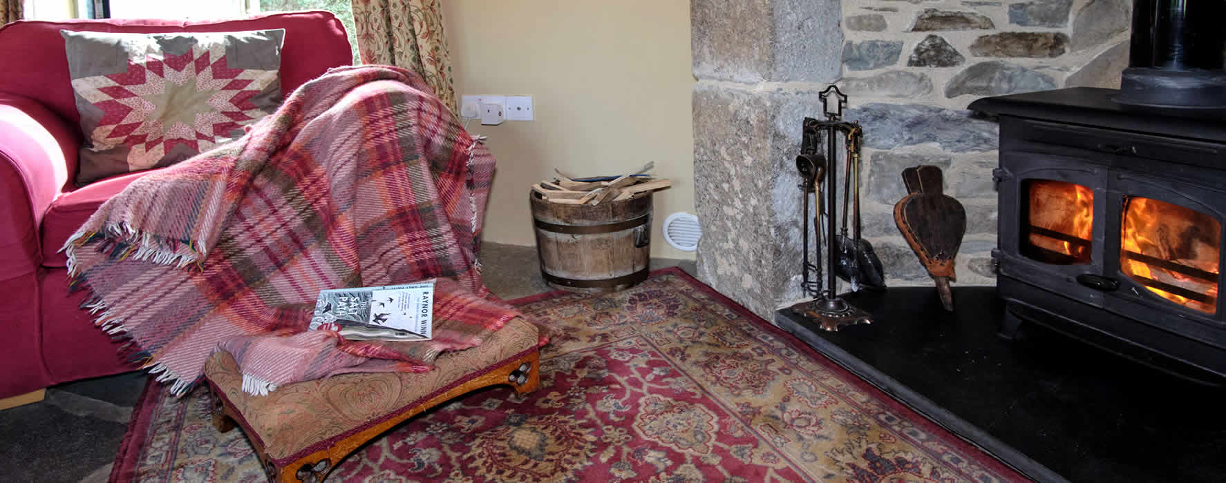 Enjoy a relaxing break in front of a cosy woodburning stove in our comfortable lounge in Honeysuckle Cottage